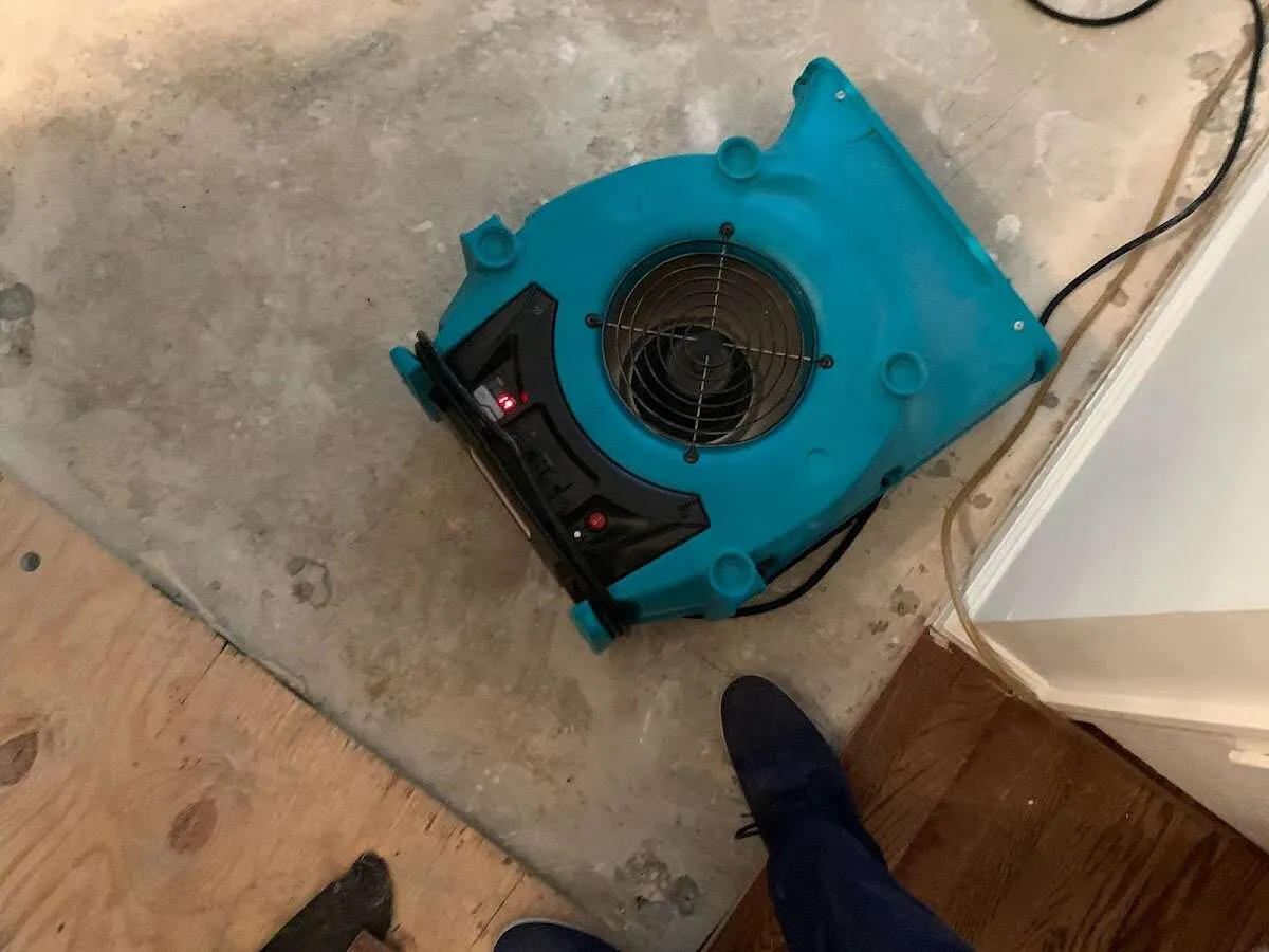 Air mover drying subfloor during Commercial Water Damage Restoration in North Valley